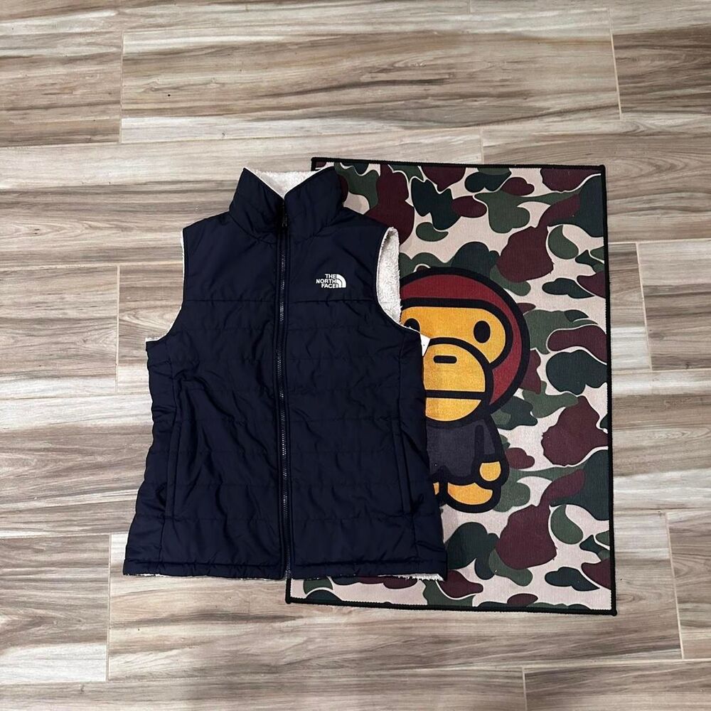 The North Face Reversible navy blue and white sherpa fleece puffer vest